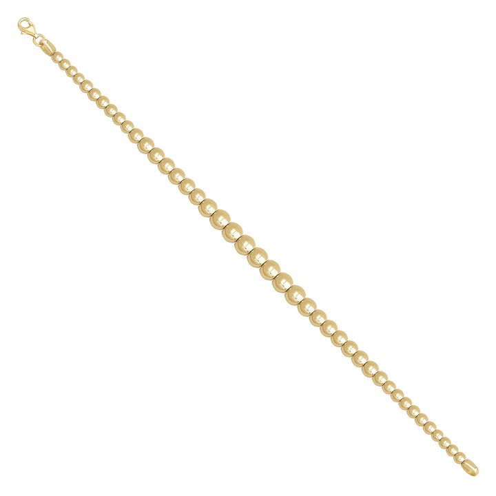 Solid gold bead bracelet, 7.65 g — shown at an angle across the frame.